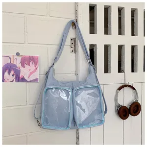 Light blue ita bag with dual clear PVC windows, versatile shoulder and crossbody design.