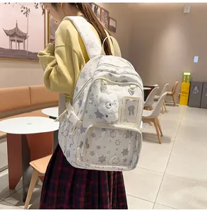 Japanese style cute star pattern school backpack with clear front pocket and plush pendant.