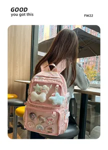 Japanese anime style pink canvas backpack with clear front pocket for pins and plush toys.