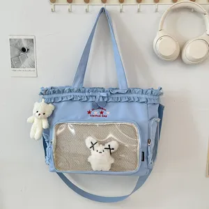 Cute Japanese style blue student tote bag with transparent ita window and cute plush pendants.