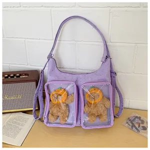 Purple ita bag detail showing transparent front pockets and cute plush bear accessories.