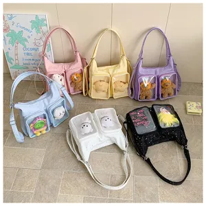 Canvas ita bag with clear front pockets for dolls and daily commuter shoulder bag options.