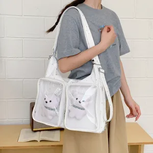 White ita bag with clear pockets and plush bear pendants, versatile shoulder and crossbody bag.