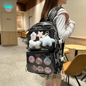 Black ita backpack with transparent front window, cute plush charms and anime pin badges for fans.