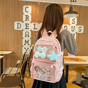 Pink anime ita bag student backpack with clear transparent window for pins and cute plush toys.