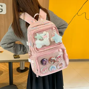 Detailed view of the pink anime ita backpack with clear window, plush toys and cute badges.