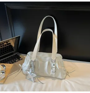 White pleated underarm shoulder bag with double straps and silver star charm detail.