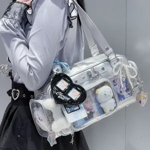 Clear window ita bag detail showing silver shoulder design with cute plush charms and accessories.