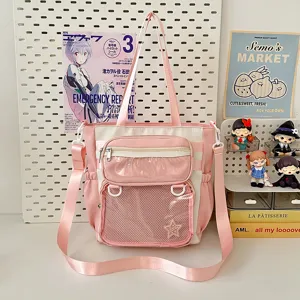 Pink and white ita bag with clear window and mesh pocket, sweet Japanese style detail view.