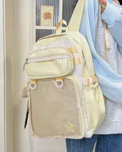 Detail view of a cute yellow ita backpack with clear mesh pocket and straps for daily use.