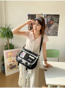 Detailed shot of Japanese style canvas messenger bag with transparent window and bow decoration.