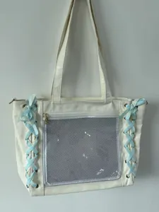 Japanese style white ita tote bag detail, featuring clear mesh pocket and cute blue ribbons.