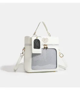 White PU doll ita bag with mesh window, cute heart embroidery, and versatile crossbody strap.
