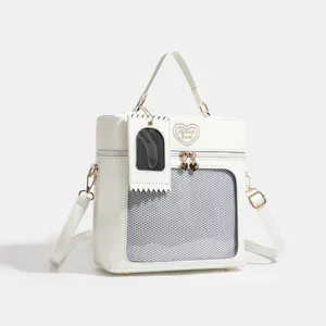 White PU leather ita bag for dolls and daily commuting with clear mesh window and crossbody strap.