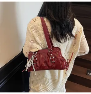 Wine red soft leather pleated shoulder bag for women, stylish underarm bag with silver charms.
