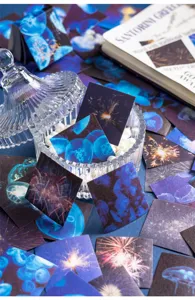 Detailed shot of square decorative stickers with jellyfish and fireworks scenic art.