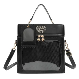 Black PU leather ita bag with clear window and heart embroidery for daily commute and doll display.