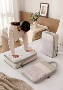 Detail view of travel compression packing cubes storage set with mesh window in beige color.
