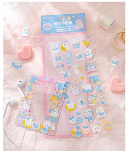 Detail view of cute blue bear planner sticker sheet with decorated card holder and sweet props.