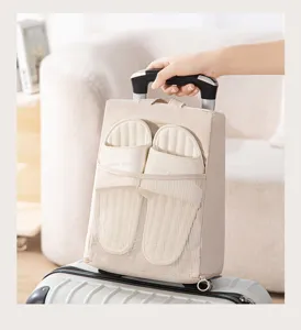 Portable travel shoe organizer bag with visible mesh pocket, convenient retractable handle design.