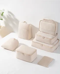 Detailed view of beige travel storage bags set with mesh design for easy organization.