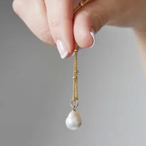 Close-up detail of the elegant baroque freshwater pearl pendant necklace, exquisite craftsmanship.
