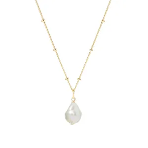 Elegant gold chain necklace featuring small bead accents and a natural baroque freshwater pearl pendant.