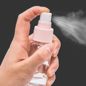Portable clear travel spray bottle with pink pump for cosmetics, lotion and liquid storage.
