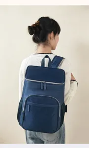 Detail view of the stylish dark blue insulated backpack with geometric front pocket.