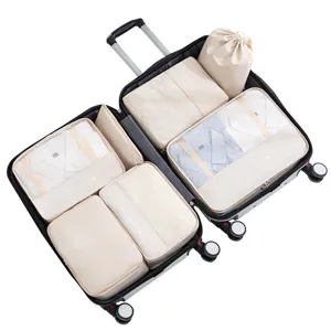 Travel packing cubes 7-piece set, beige mesh organizers and storage bags for luggage organization.