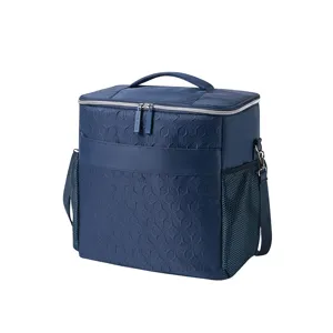 Dark blue insulated cooler bag for picnic and lunch with shoulder strap and mesh side pockets.