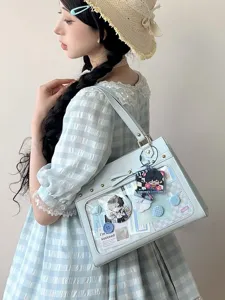 Detailed view of light blue Ita bag with transparent window, ACG badges and pins for daily use.