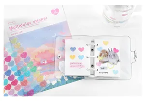 Detailed shot of glittering PET sticker sheet with cute galaxy hearts and decorative journal items.