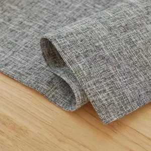 Close up of grey textured linen table runner detail, showcasing fabric quality and weave.
