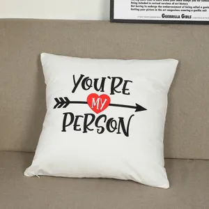 Detail shot of a white plush throw pillow cover with love heart and English quote text.