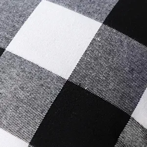 Close up of black and white check cotton pillowcase fabric, soft and durable home textile.