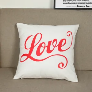 White velvet pillow cover featuring red Love typography, perfect for home decor detail.