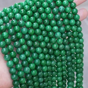 Detailed close-up view of vibrant green round loose gemstone beads for DIY jewelry making parts.