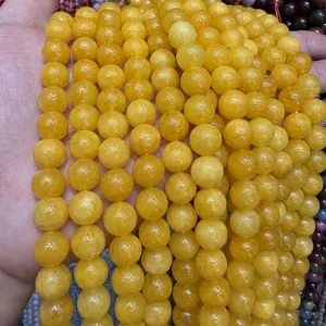 Natural yellow stone round loose beads detail shot, high quality DIY bracelet jewelry accessory.