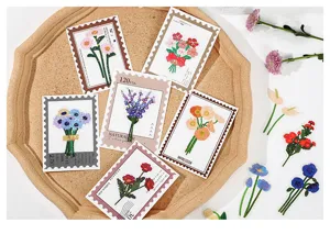 Detailed close-up of floral PET stickers on a tray, aesthetic plant stationery items.