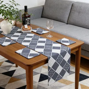 Blue and white patterned linen table runner and matching coasters set for home dining room decor.