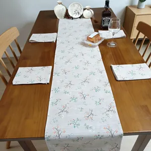 Linen floral table runner detail showing pastoral print design on dining table decor.