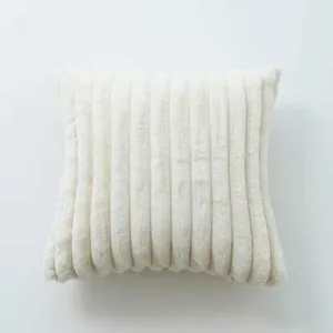 Close-up detail of soft white faux rabbit fur striped throw pillow for cozy home decor.