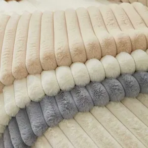Close-up detail of soft ribbed faux fur plush throw pillow, warm striped design for sofa bed.