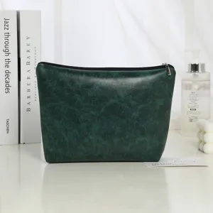 Dark green PU leather cosmetic bag with secure zipper, waterproof toiletry pouch for daily storage.