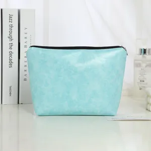 Detail view of turquoise PU leather cosmetic bag with black zipper, perfect makeup storage pouch.