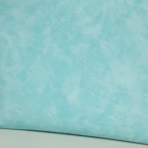 Close-up detail shot of light blue textured synthetic leather material for custom bags.