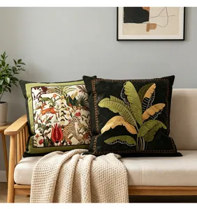 Vintage throw pillows detail shot showcasing tropical jungle animal and banana leaf designs