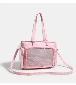Detail view of pink ita bag with clear mesh front pocket and star print for anime fans.