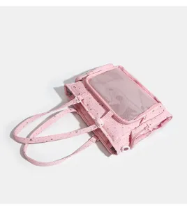 Pink star patterned tote bag detail showing mesh window and sturdy handles for daily use.